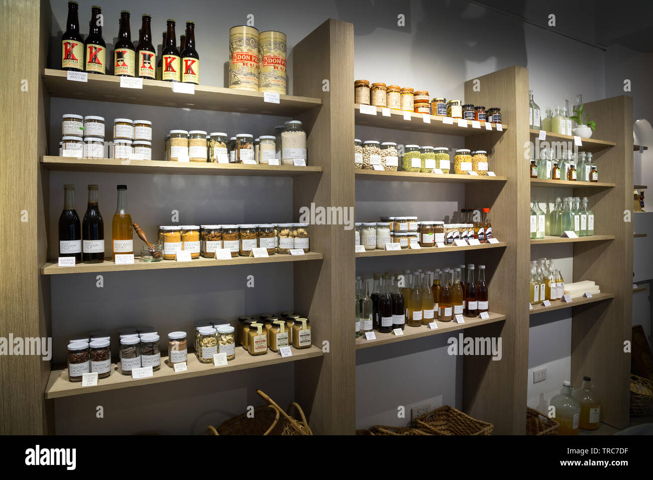 Manila, Philippines - August, 4, 2016: Wooden shelves in a shop full og jars and bottles with natural organic products Stock Photo