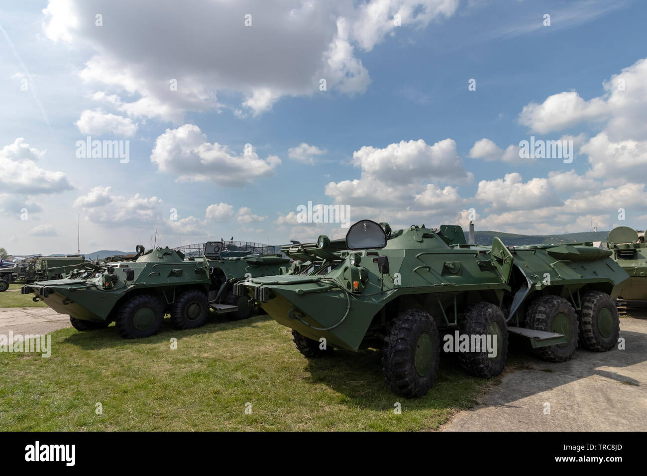 Russian BTR-80  8×8 wheeled amphibious armoured personnel carriers parking in a field, hatch doors open. No insignia, can be anywhere. Stock Photo