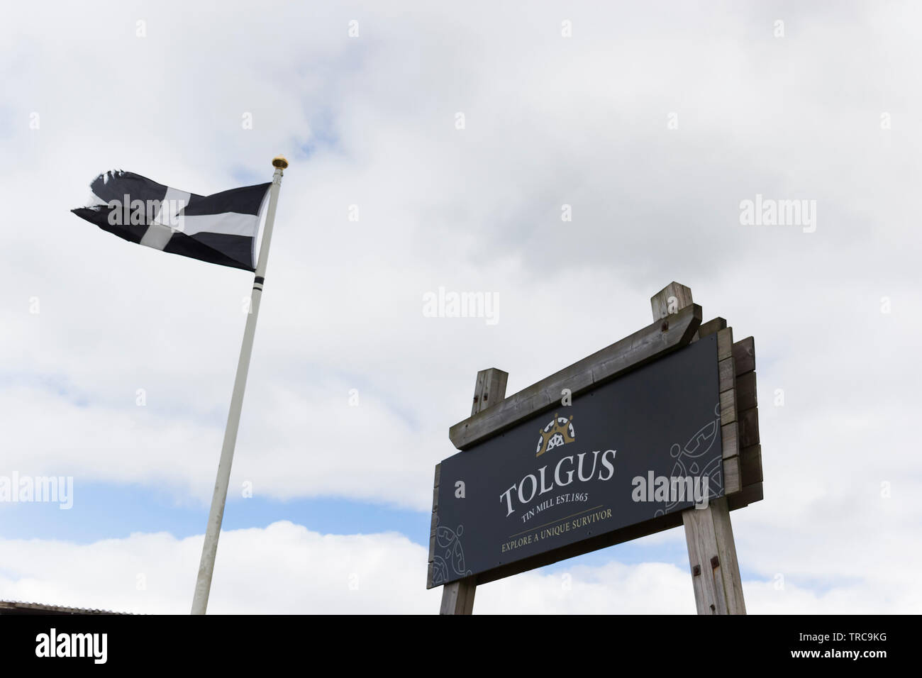 Cornish flag of Saint Piran at the entrance to Tolgus Mill selling jewellery made on site and housing a tin mine restoration project at Redruth. Stock Photo