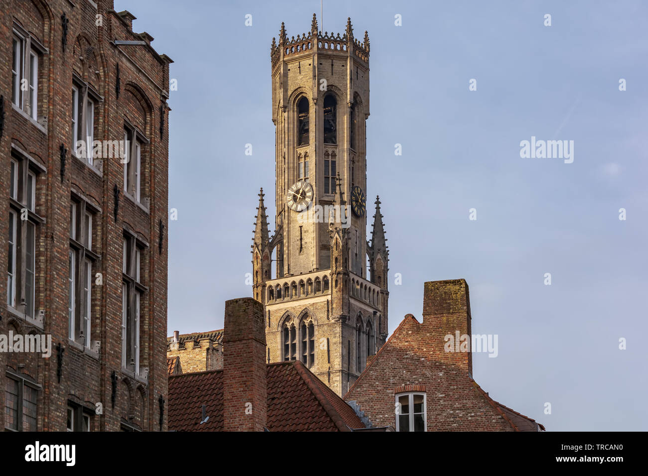 Belfry of Bruges, the medieval bell tower against blue sky. The 83 meter high belfry or hallstower (halletoren) is Bruges' most well-known landmark Stock Photo