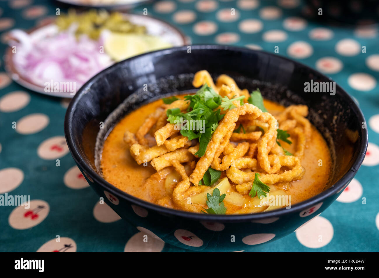 Northern Thai Food Of Coconut Curry Noodle Soup With Chicken Khao Soi In Black Bowl Stock Photo Alamy