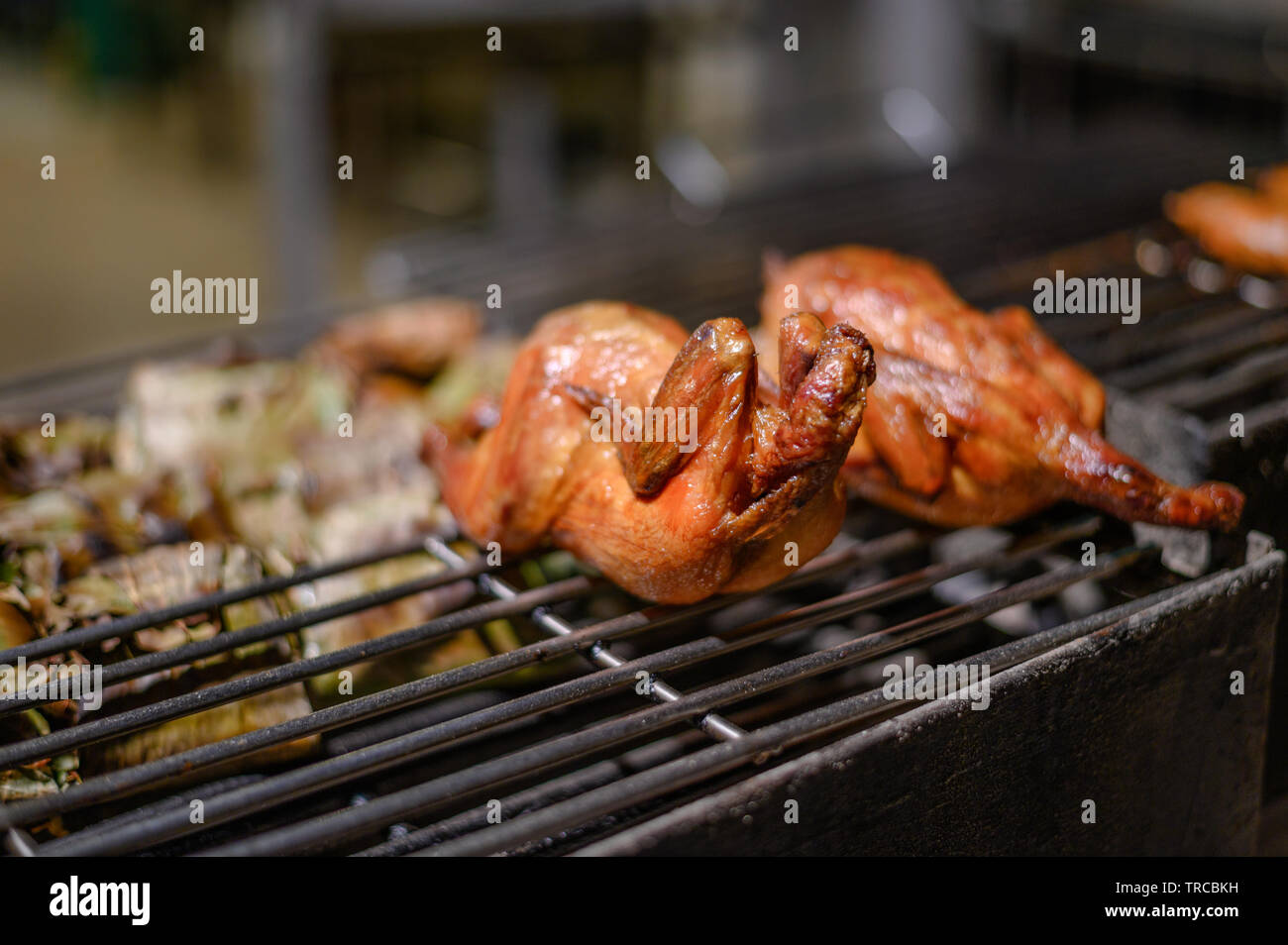 Roasting whole chicken on grille in night market Stock Photo Alamy