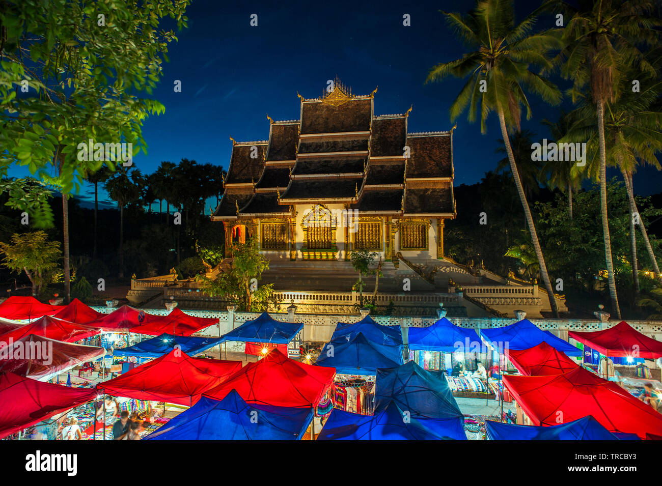 The Hmong night market with Haw Pha Bang temple in the background in central Luang Prabang, a World Heritage listed town in the Lao PDR. Stock Photo