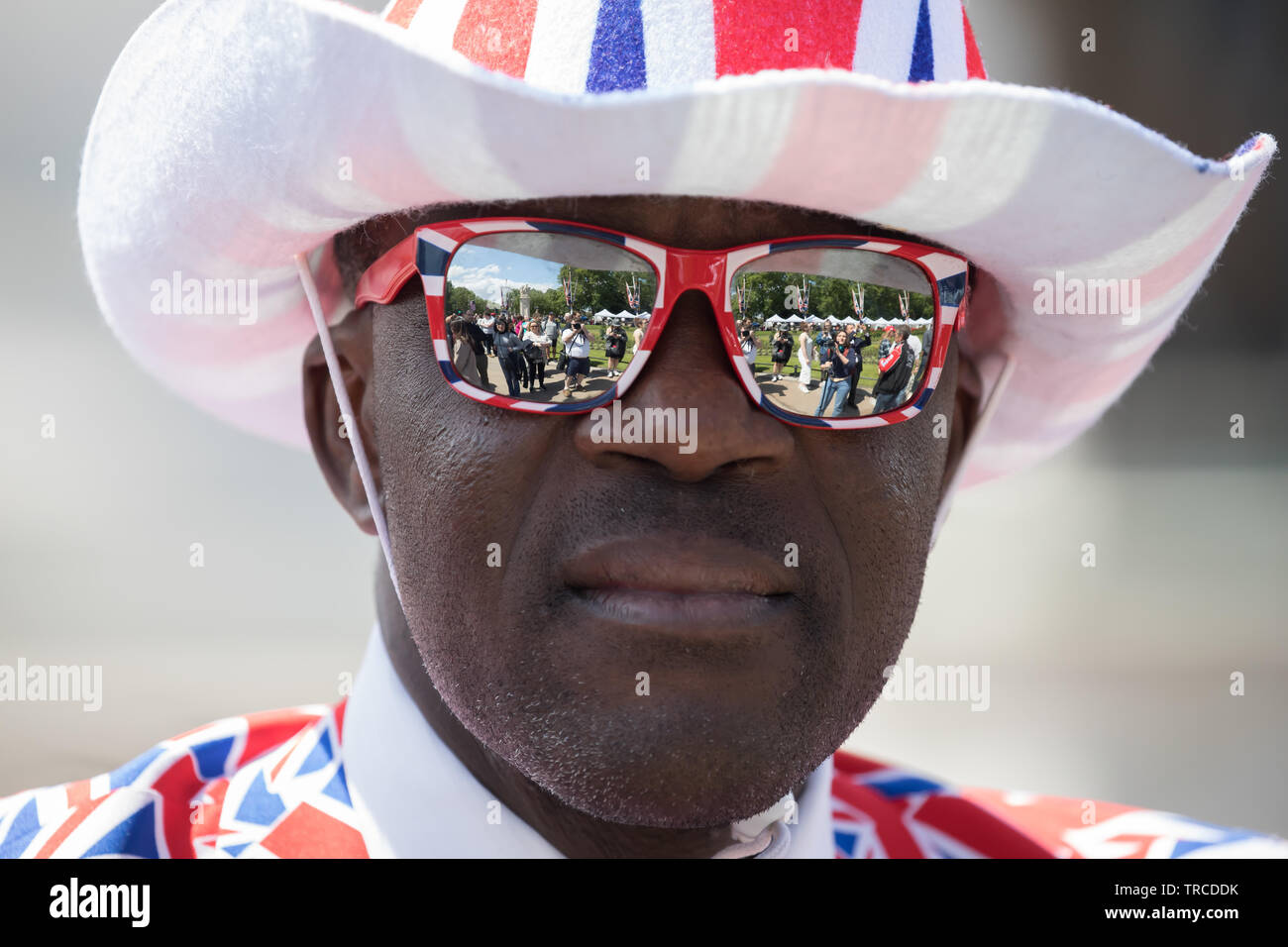 London, UK. 3rd June, 2019. A black man dressed from top to toe in union  kjack flags awaits President Trump and his wife Melania's arrival at  Buckingham Palace by Helicopter, Marine One.