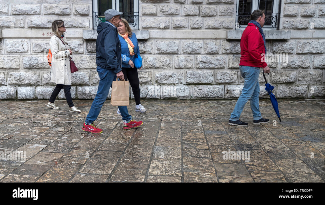Montenegro, April 30th 2019: Street scene with tourists walking at the Old Town of Kotor after rain Stock Photo