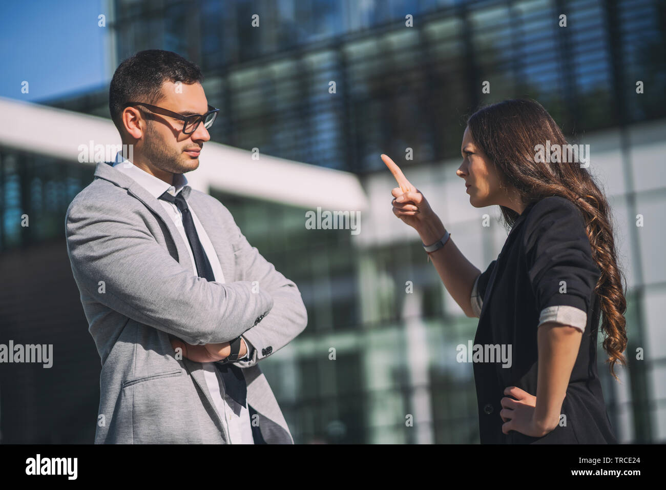 Business colleagues are arguing outside the company building. Stock Photo