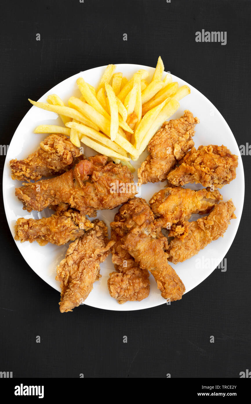Tasty fried chicken drumsticks, spicy wings, French fries, chicken