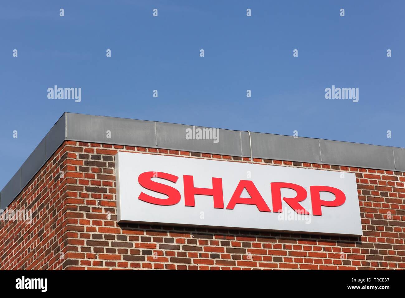 Ega, Denmark - September 25, 2016: Sharp logo on a facade. Sharp is a Japanese multinational corporation Stock Photo