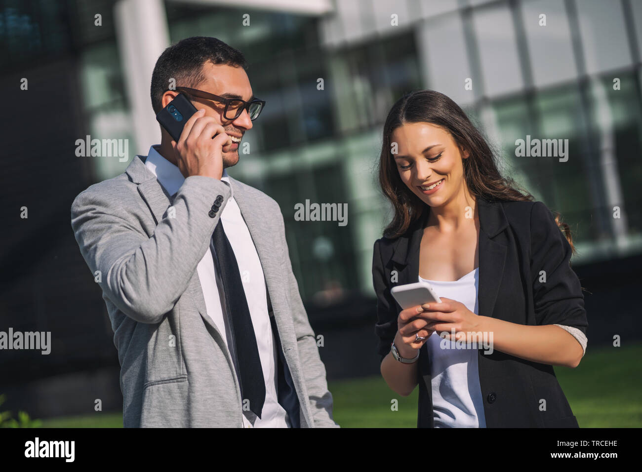 Business colleagues are communicating outside the company building ...