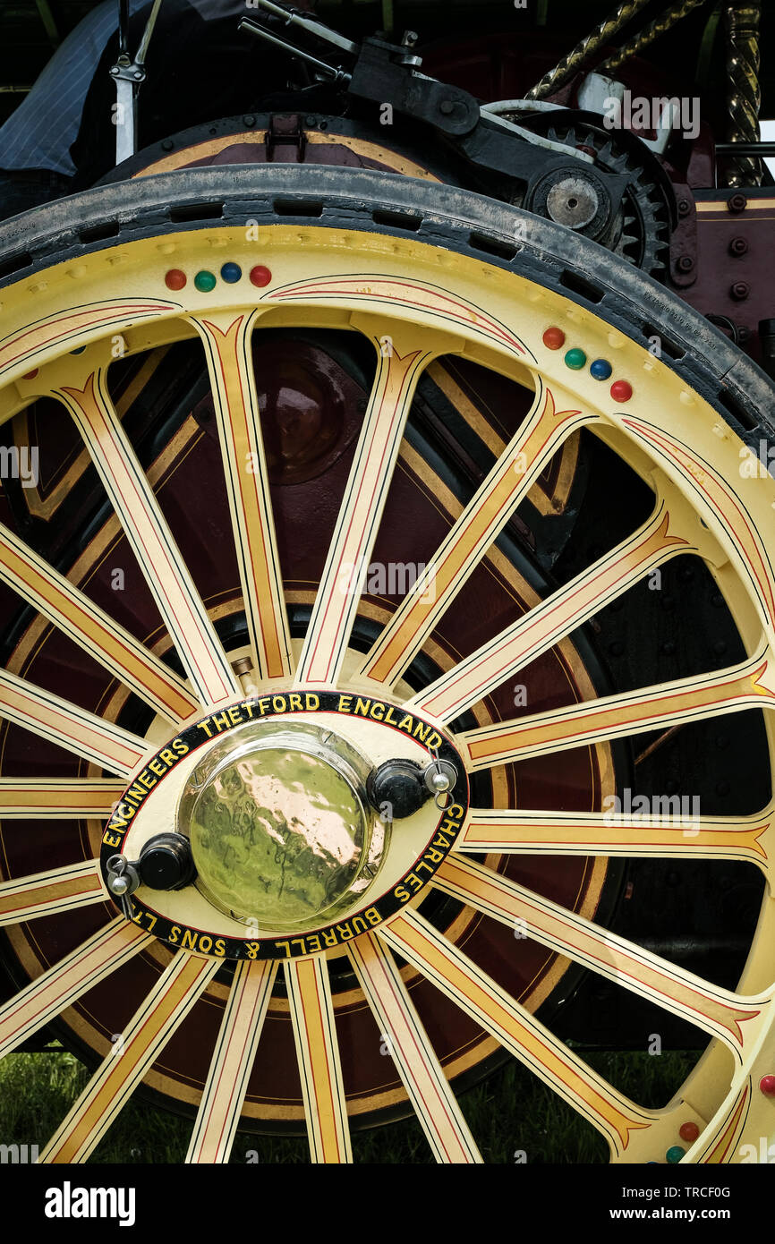 Close-up of the side and large yellow wheel of a vintage traction engine Stock Photo