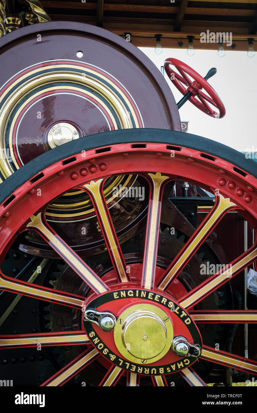 Close-up of the side and large wheel of a red vintage traction engine Stock Photo