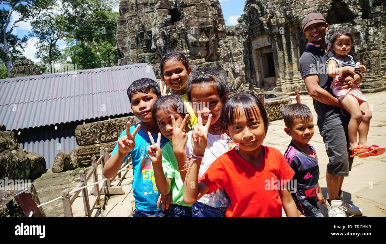A group of local Cambodia kids posing in front of camera at Bayon Temple. (Angkor Wat, UNESCO World Heritage Site, Siem Reap, Cambodia) Stock Photo