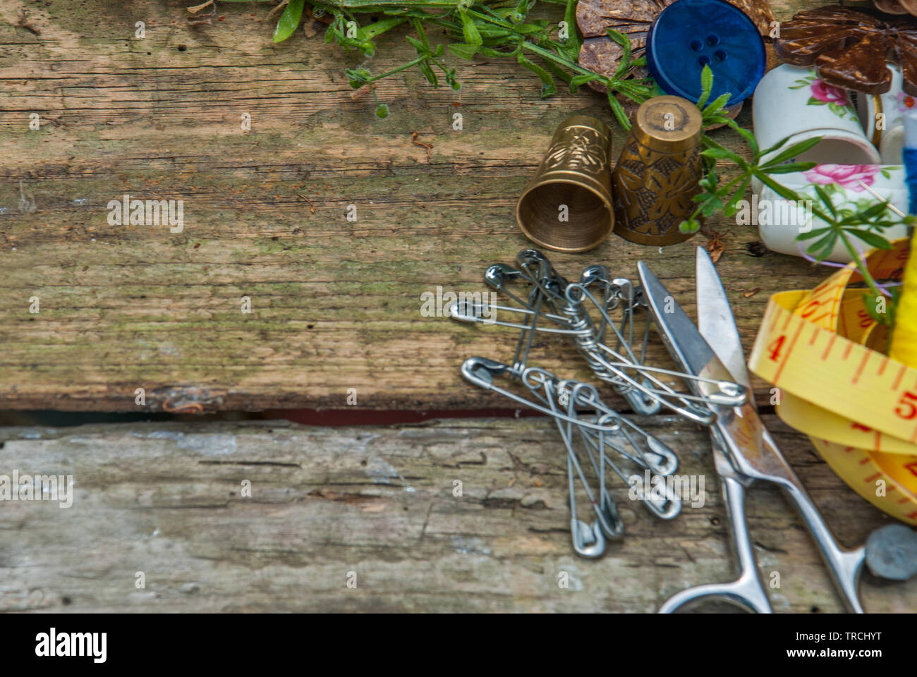 Spools of thread and basic sewing tools including pins, needle, a ...
