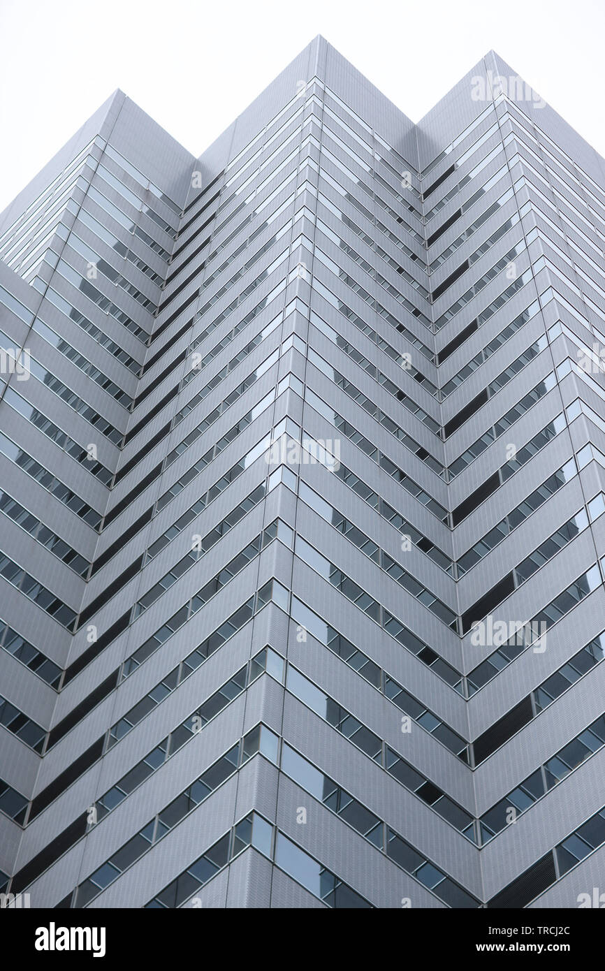 Angled protrusions of tall buildings of glass and concrete financial and business center of the modern city Stock Photo