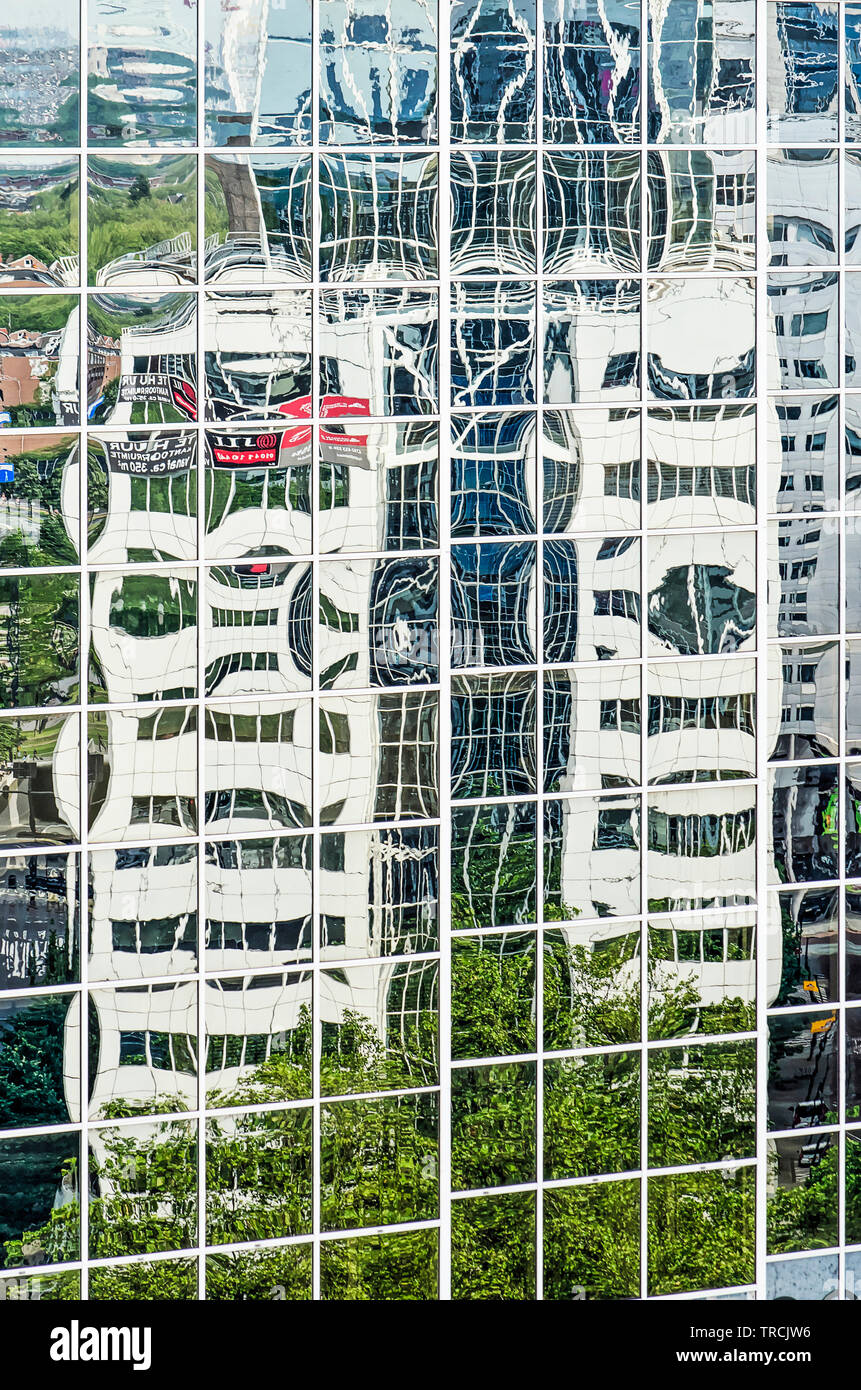 Rotterdam, The Netherlands, June 2, 2019: two office buildings on eiter side of Hofplein roundabout reflect in each other mirror glass facades Stock Photo