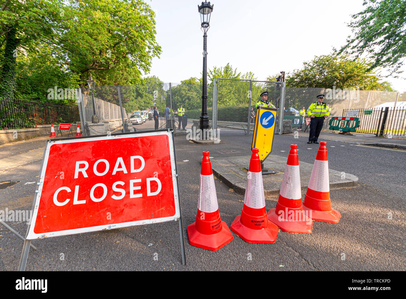 Police guarding closed road. Security around Winfield House, Regent's Park, London, UK for the