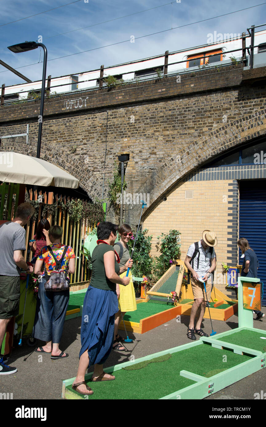 London, Hackney. London Fields. Crazy mini golf at the back of a railway arch. Stock Photo