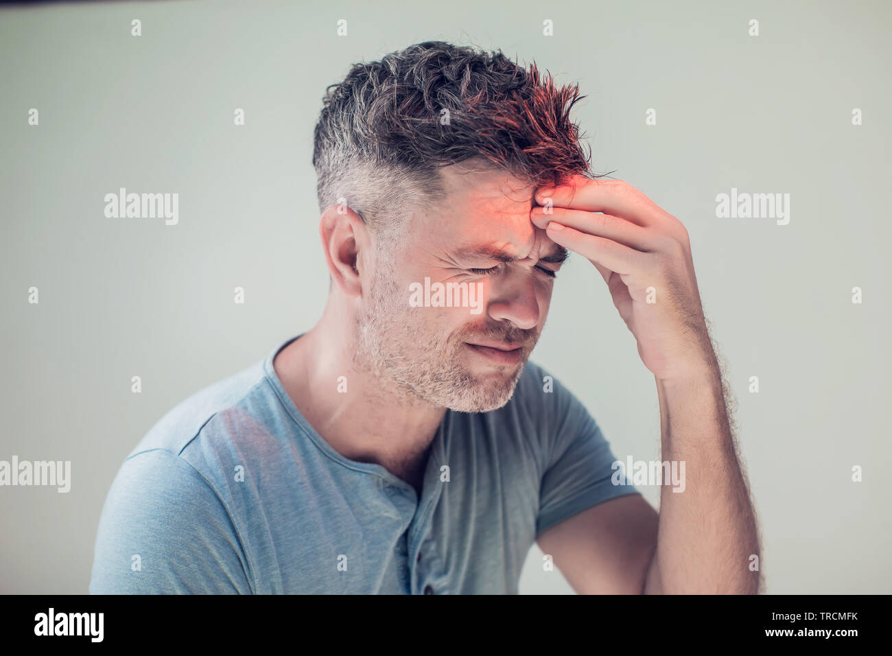 Handsome young man suffering from headache Stock Photo