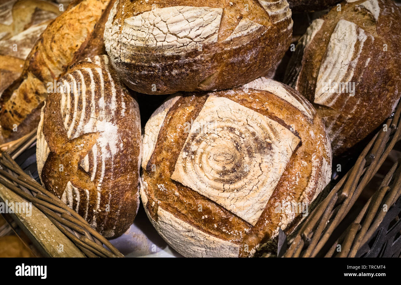 Fresh handmade artisan loaves of bread for sale on display in a basket Stock Photo Alamy