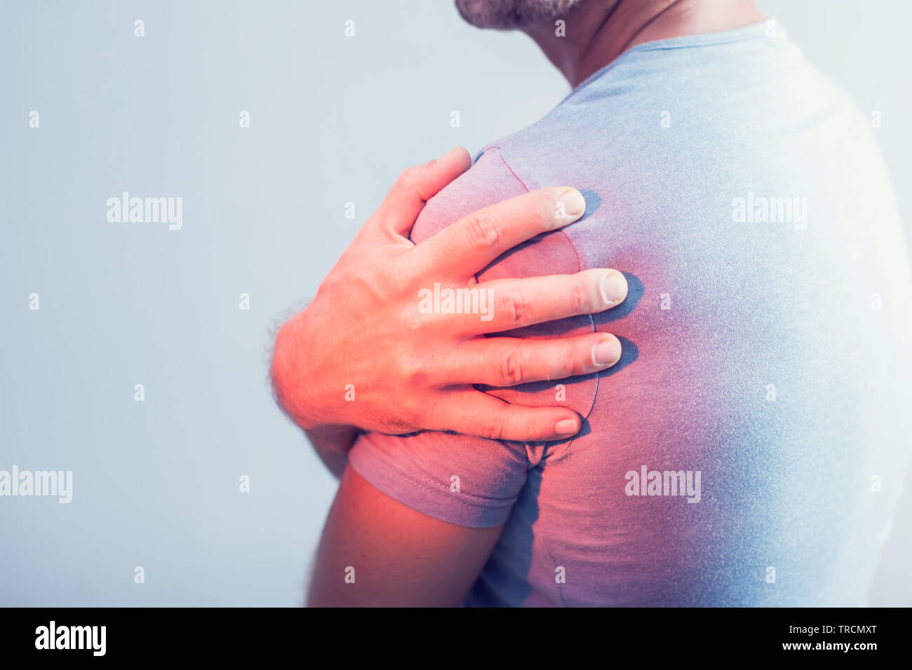 Close up of Man with shoulder pain or neck pain on white background,Health concept Stock Photo