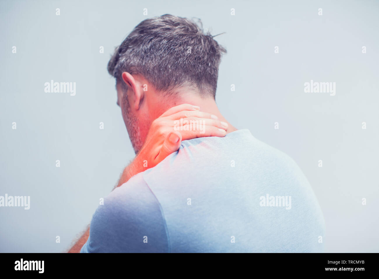 People, healthcare and problem concept - close up of man suffering from neck pain over gray background Stock Photo