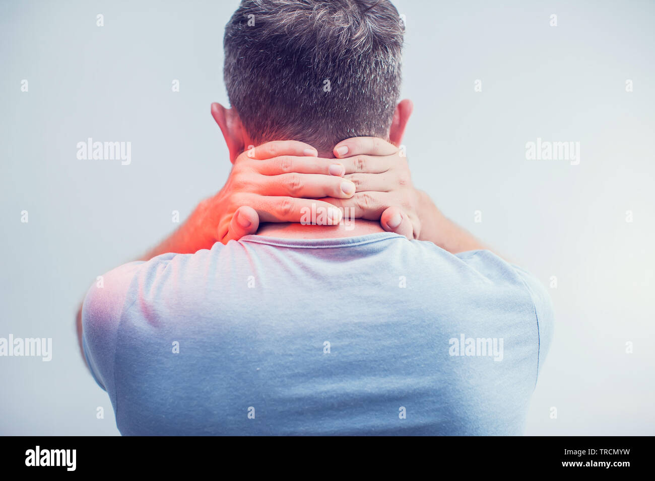 People, healthcare and problem concept - close up of man suffering from neck pain over gray background Stock Photo