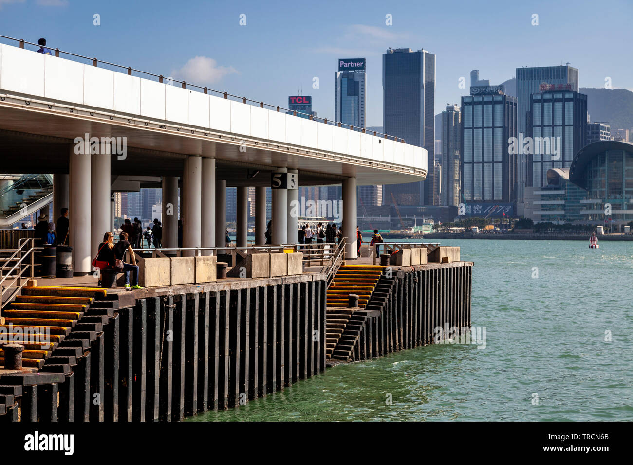 Passengers Wait At The Star Ferry Pier, Kowloon, Hong Kong, China Stock Photo