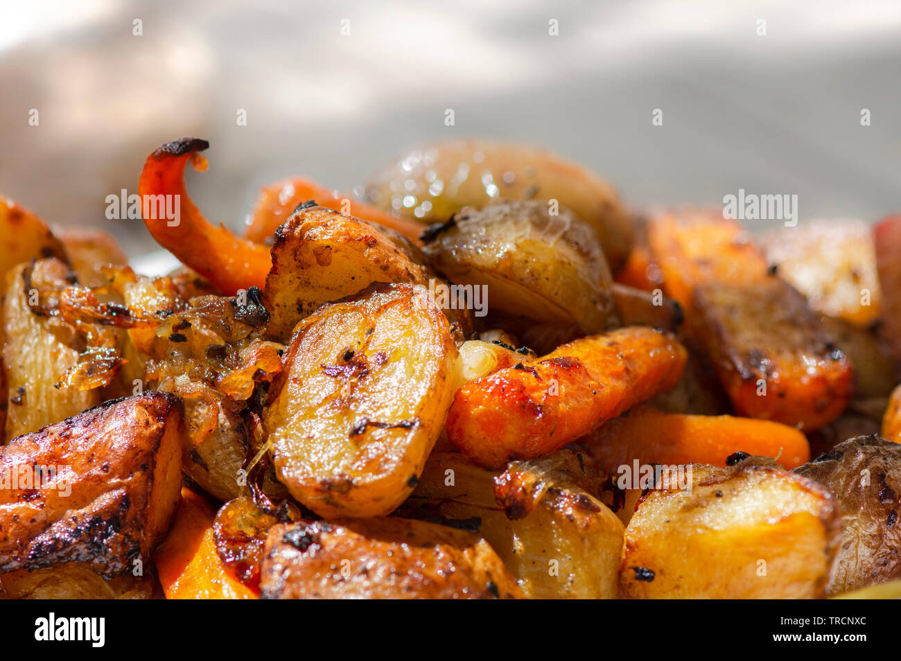 Oven roasted potatoes with onions and carrots. Stock Photo