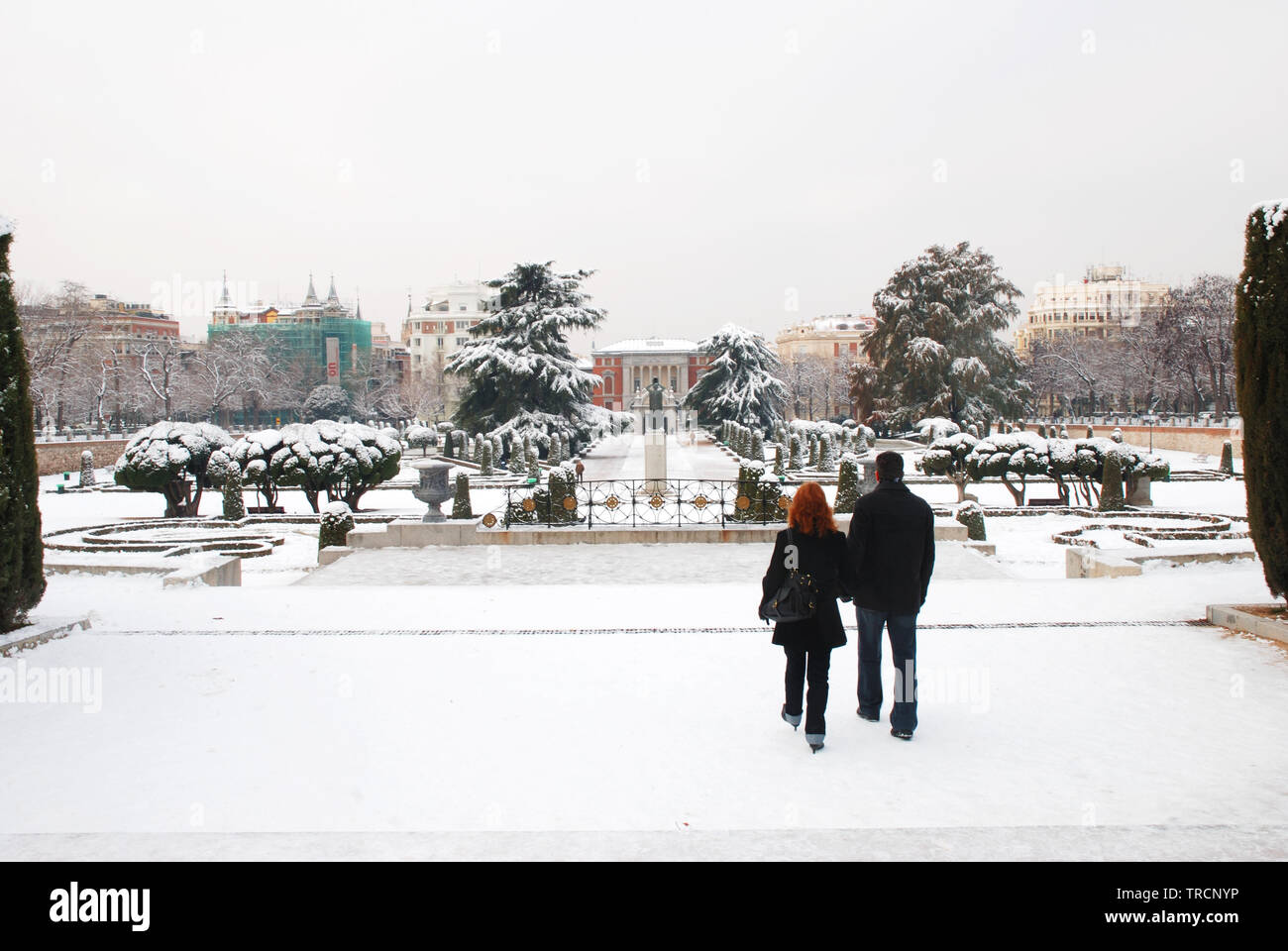 Couple walking along snow covered Retiro park. Madrid, Spain. Stock Photo