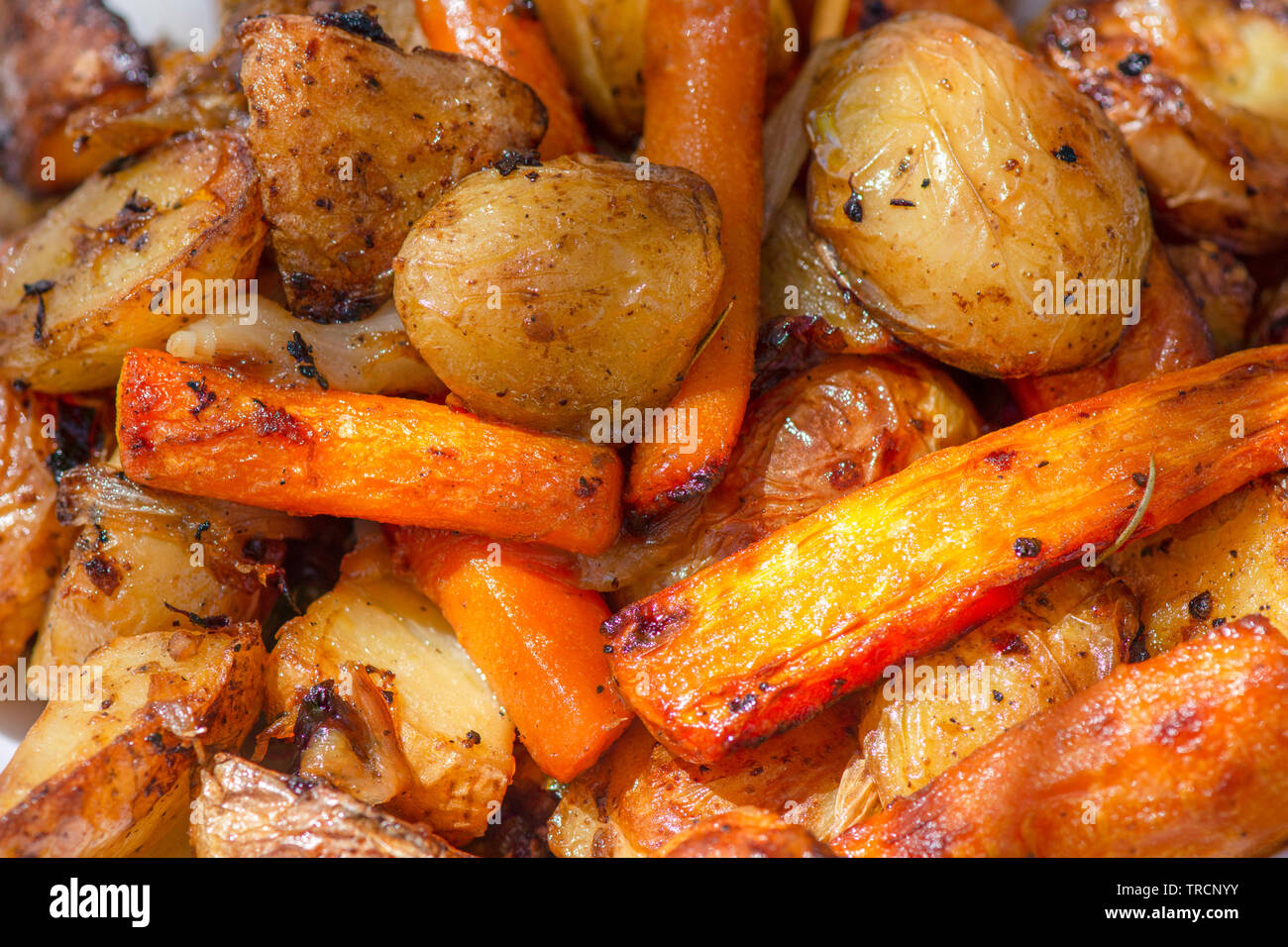 Oven roasted potatoes with onions and carrots. Stock Photo