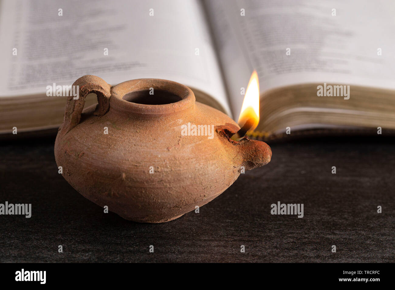 A Lit Ancient Oil Lamp with an Open Bible Thy Word is a Lamp Unto My