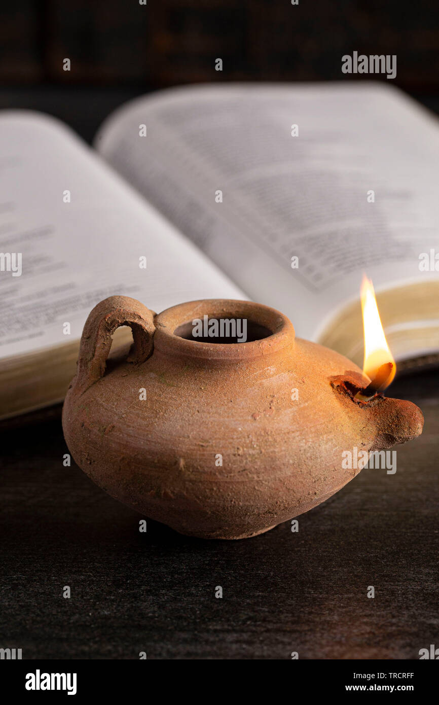 A Lit Ancient Oil Lamp with an Open Bible Thy Word is a Lamp Unto My