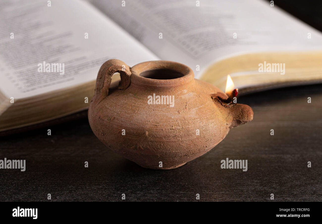 A Lit Ancient Oil Lamp with an Open Bible Thy Word is a Lamp Unto My