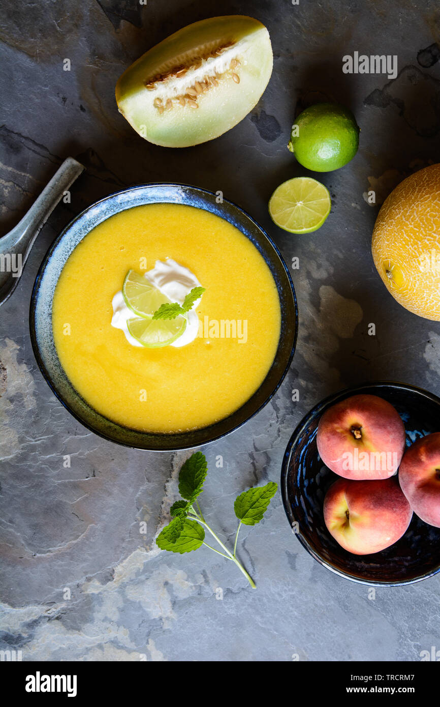 Refreshing  summer fruit soup with Galia melon and peaches Stock Photo