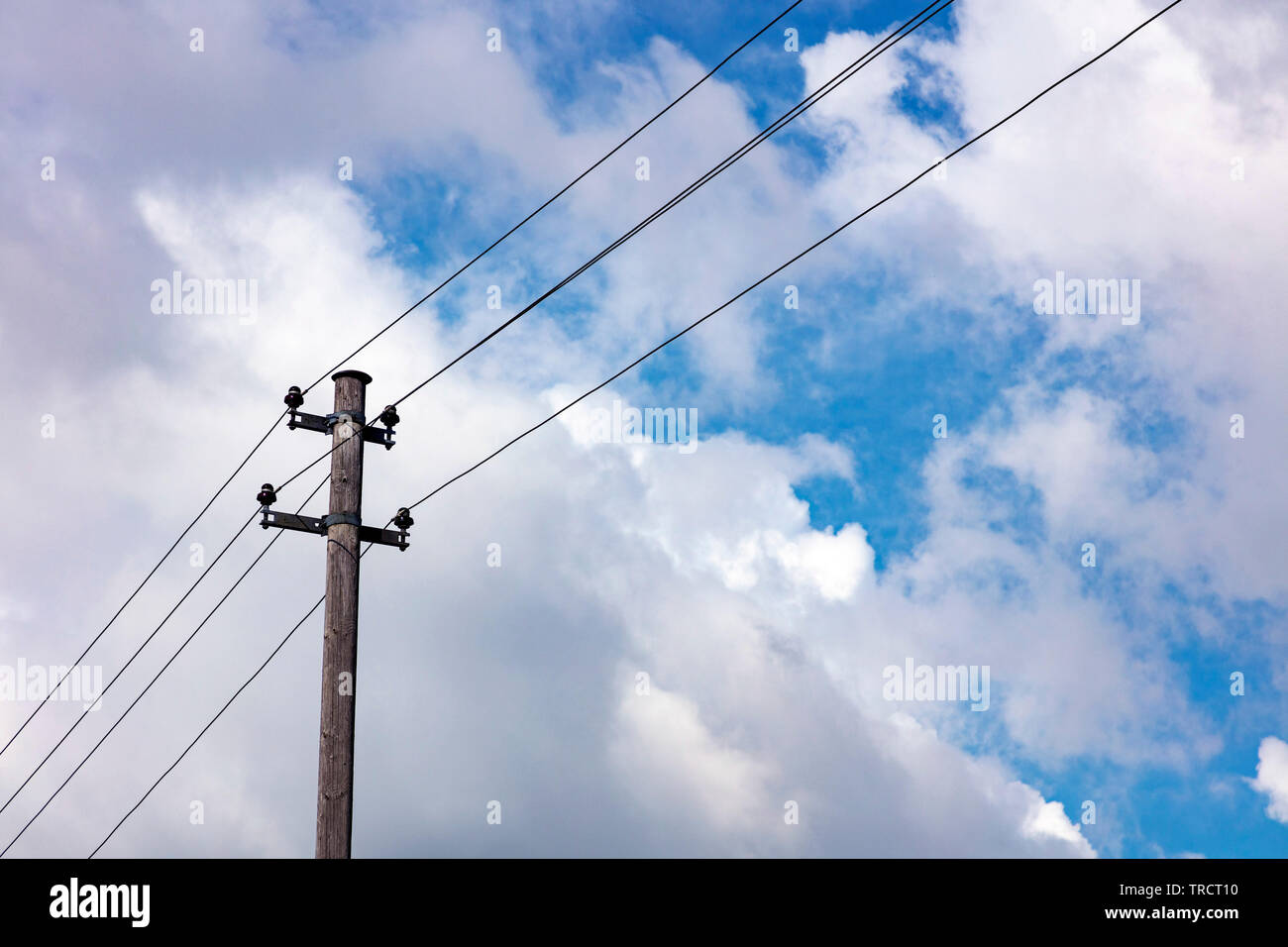 Old power line at wooden mast Stock Photo