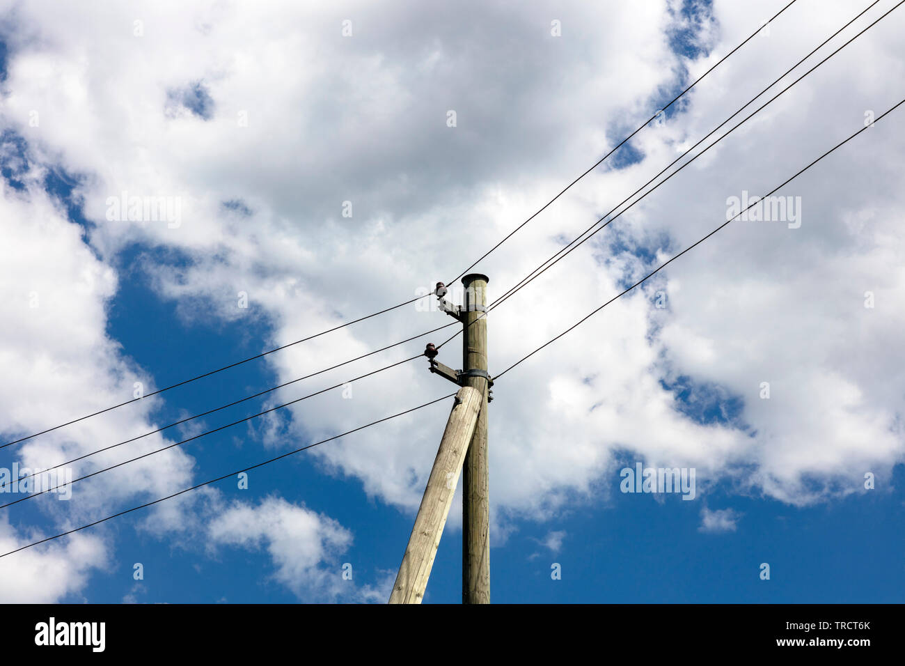 Old power line at wooden mast Stock Photo