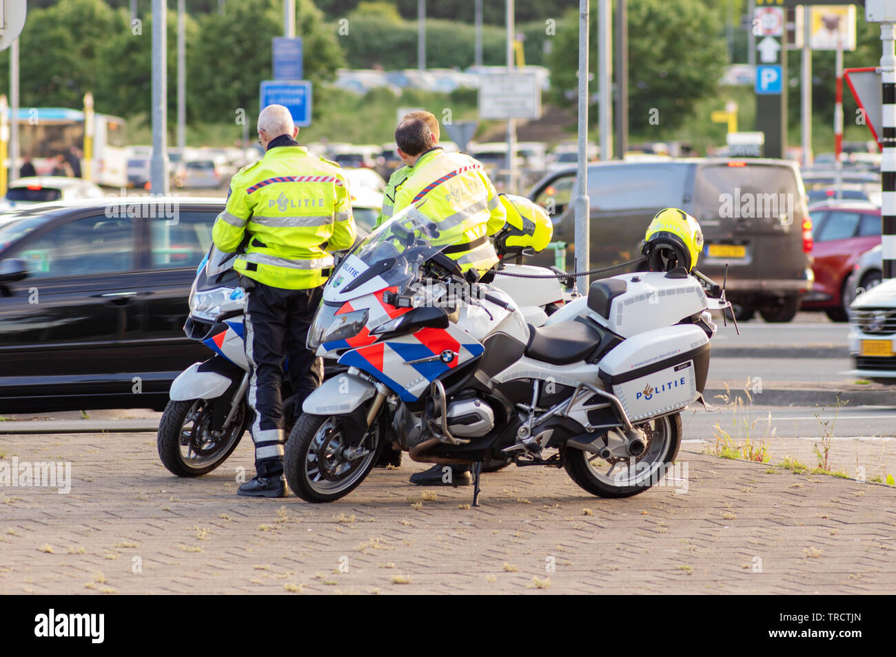Arnhem, Netherlands - May 28, 2019: Dutch police officers are standing by their bikes at the Gelredome stadium Stock Photo