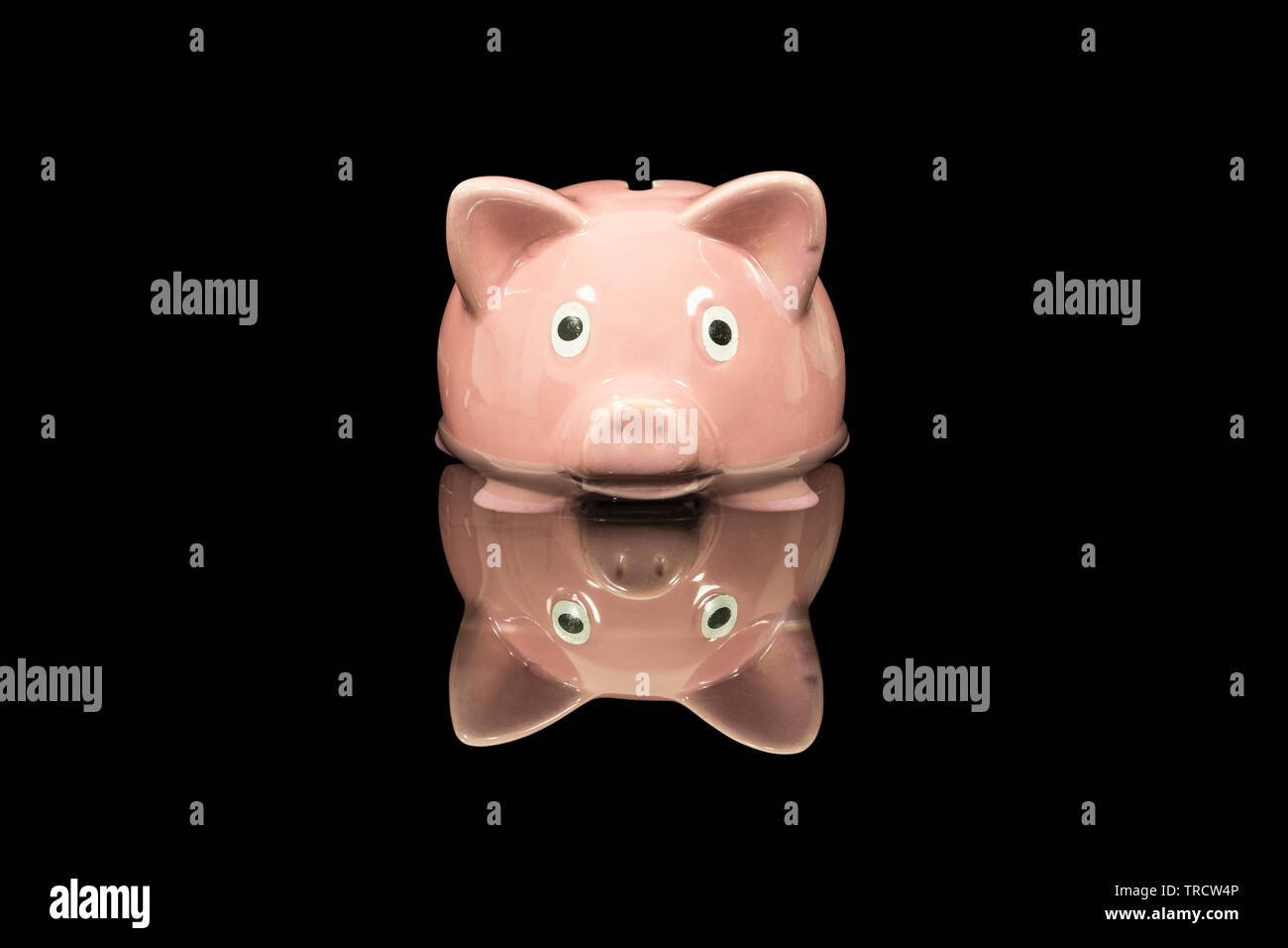 Vintage piggy bank toy up to its nose in deep dark water. Stock Photo