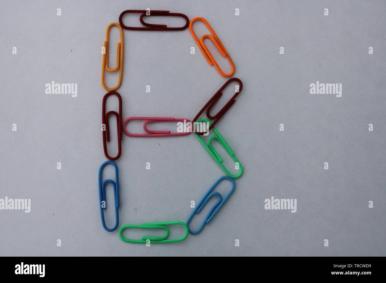 Letter B made with colorful paper clips on white background Stock Photo