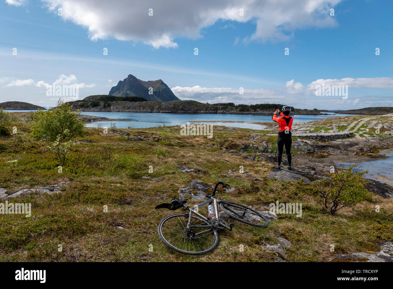 Female cyclist visiting Vega Island, Norway Stock Photo