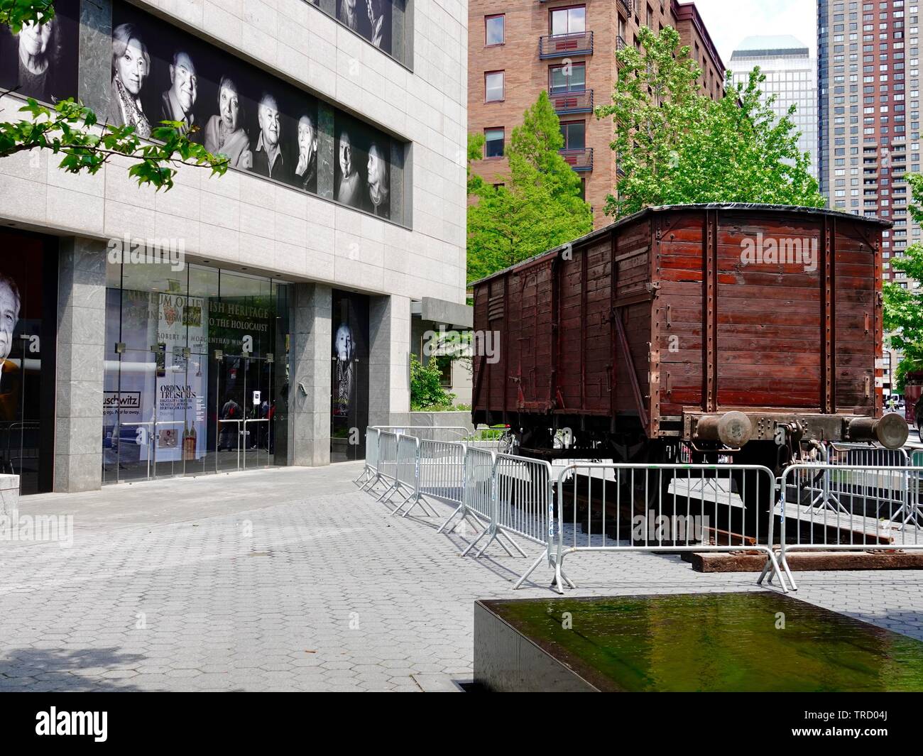 Front exterior of the Museum of Jewish Heritage: A Living Memorial to the Holocaust, with a freight car used during WWII, Manhattan, New York, NY, USA Stock Photo