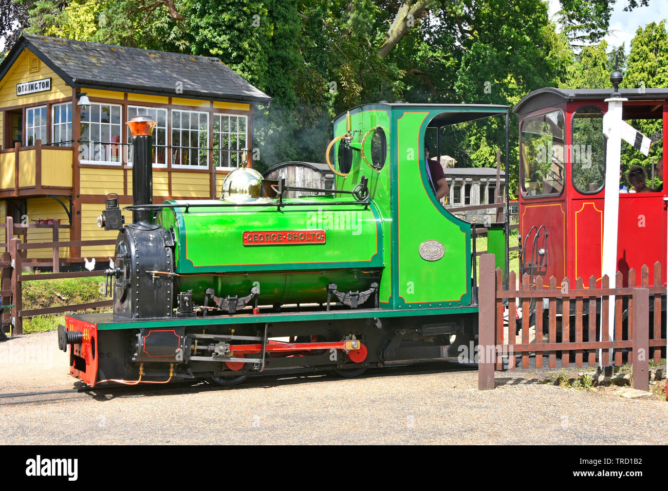 Bressingham gardens  steam engine  locomotive George Sholto number 994 & train passing signal box transporting visitors around gardens East Anglia UK Stock Photo