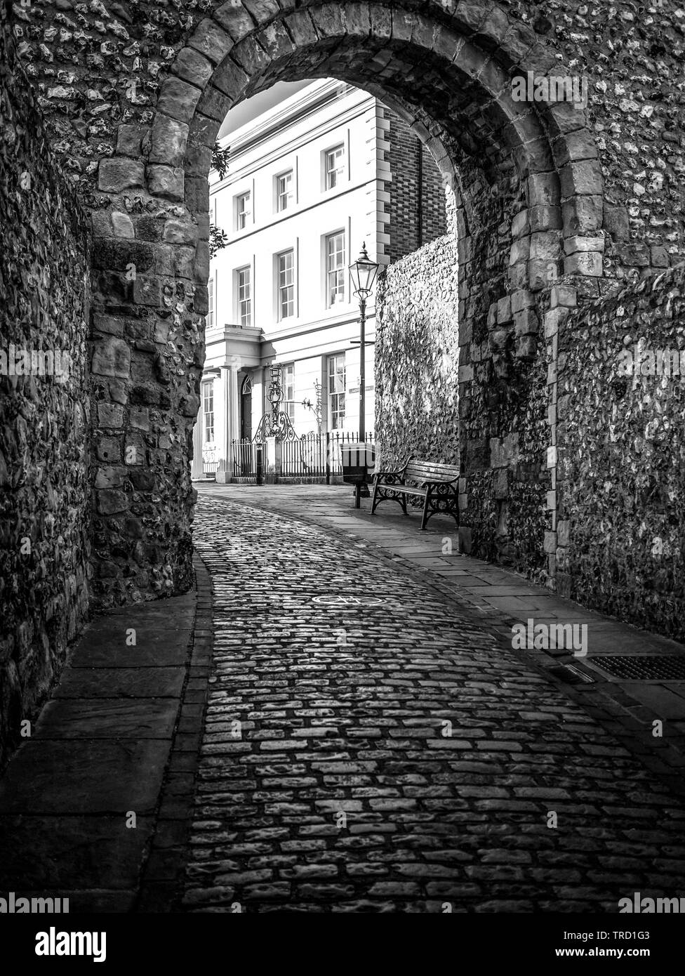 14th Century cobblestone path way through Barbican Gate underpass taken at Lewes Castle, East Sussex, on the 21st of May 2015, in a B&W monotone Stock Photo