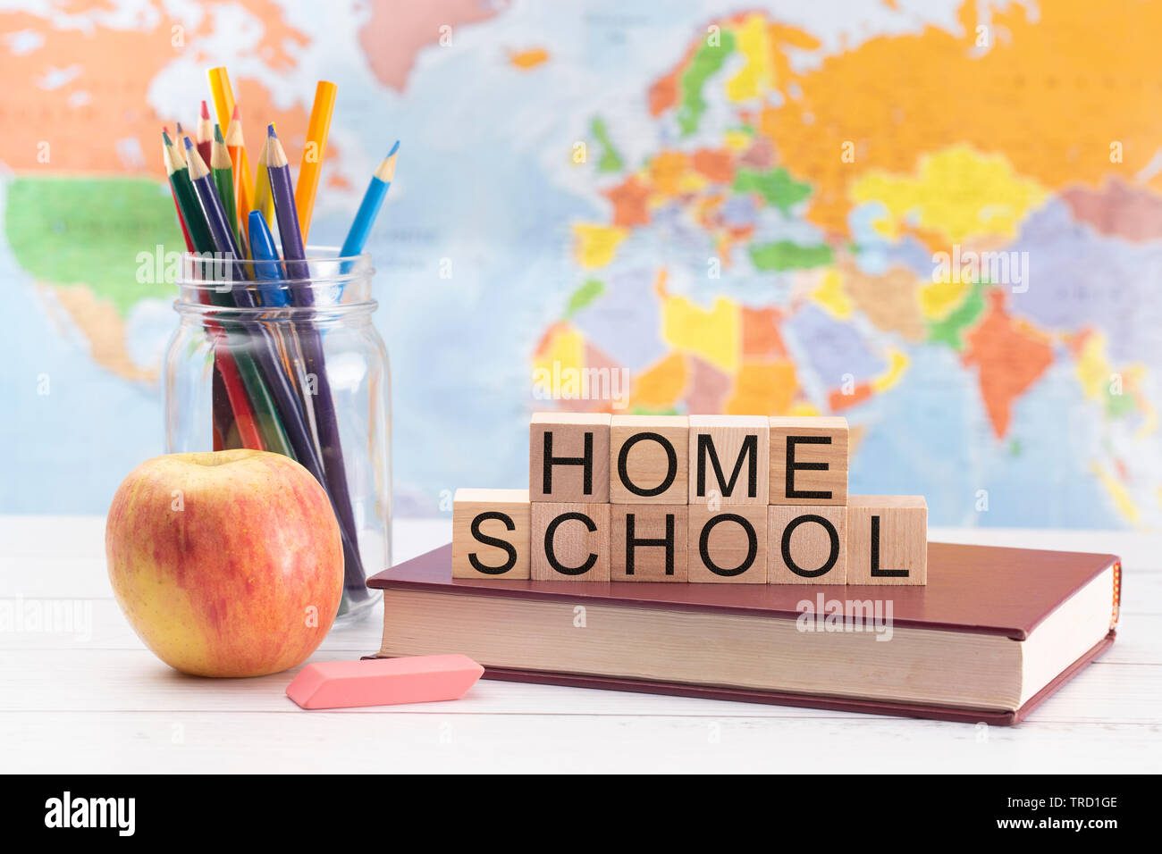 Home Schooling Background with School Supplies and a World Map Stock Photo