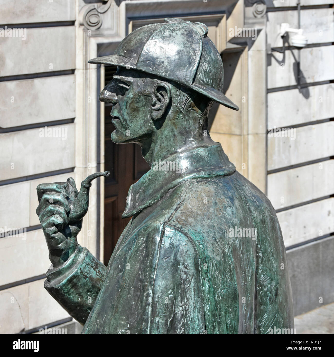 Close up back head & shoulders part of Sherlock Holmes bronze statue by sculptor John Doubleday with pipe cloak face & hat near Baker Street London UK Stock Photo