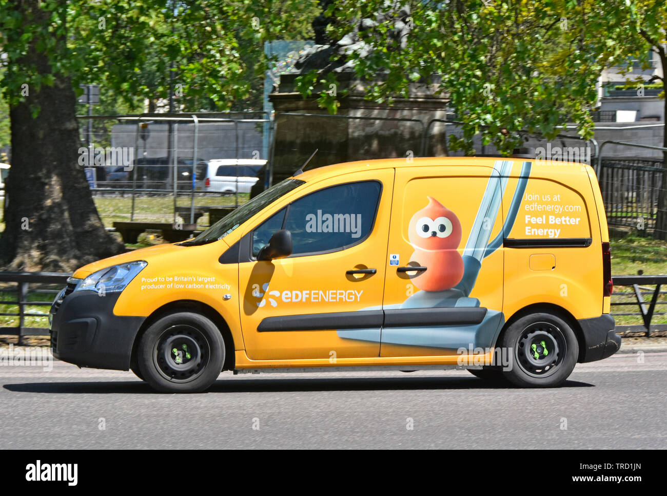 EDF yellow van French business side view of advertising to encourage customers to switch energy supplies via graphic art of vacuum cleaner London UK Stock Photo
