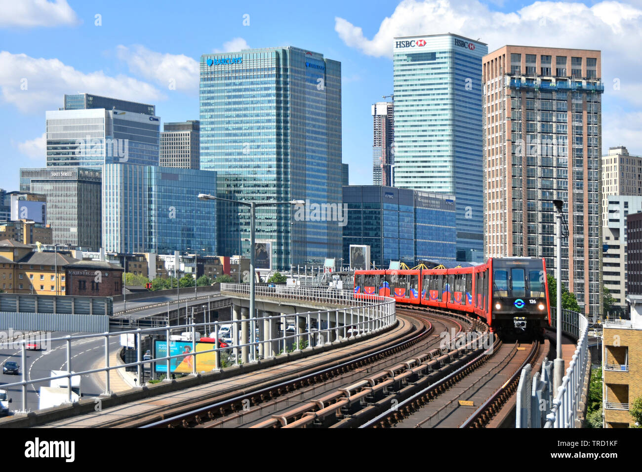 East London urban landscape inTower Hamlets with building development at Canary Wharf banking business offices & public passenger transport railway UK Stock Photo