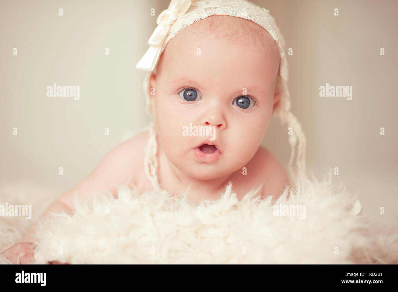 Cute surprised baby lying in bed. Looking at camera. Childhood Stock Photo Alamy