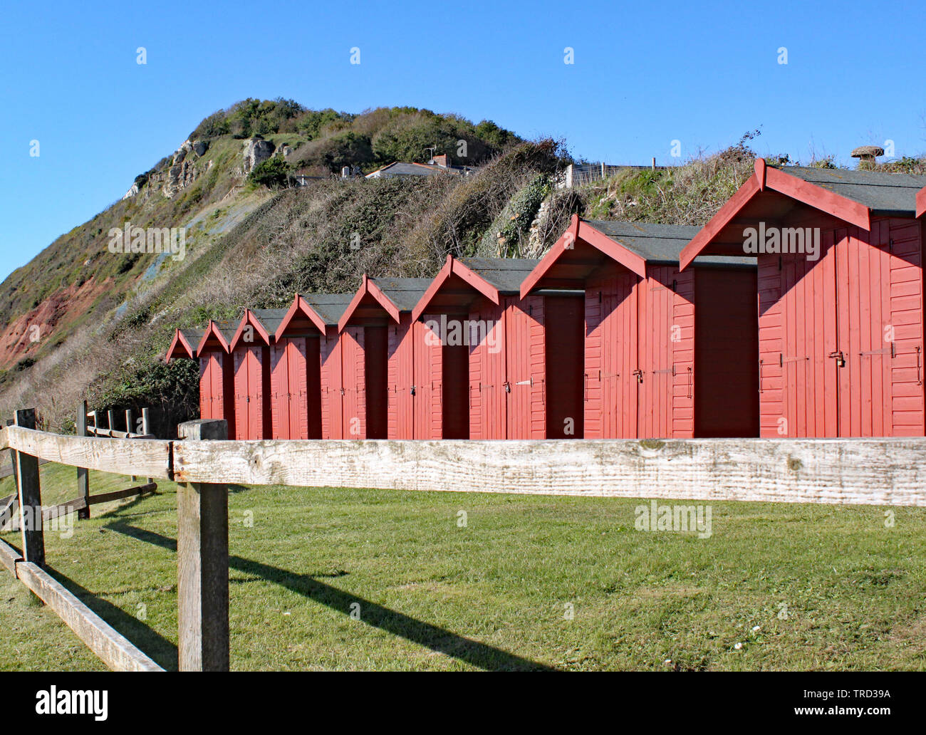 A row of beach huts on the shingle beach at Branscome in Devon, England. Stock Photo