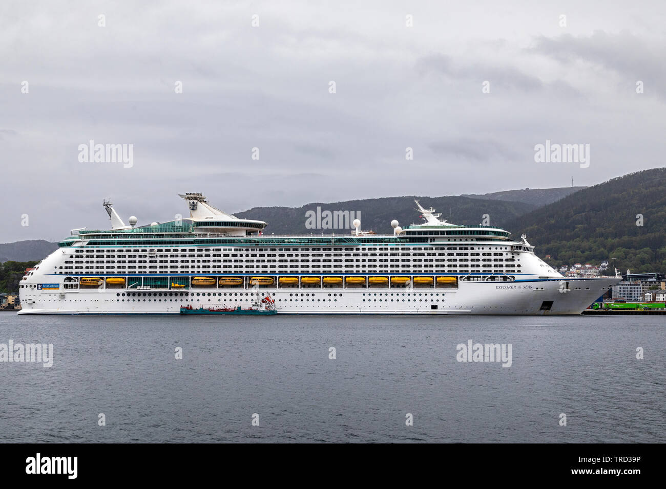 Cruise ship Explorer Of The Seas at Jekteviksterminalen terminal in the port of Bergen, Norway. A rainful and cloudy day. Tanker Oslo Tank delivering Stock Photo